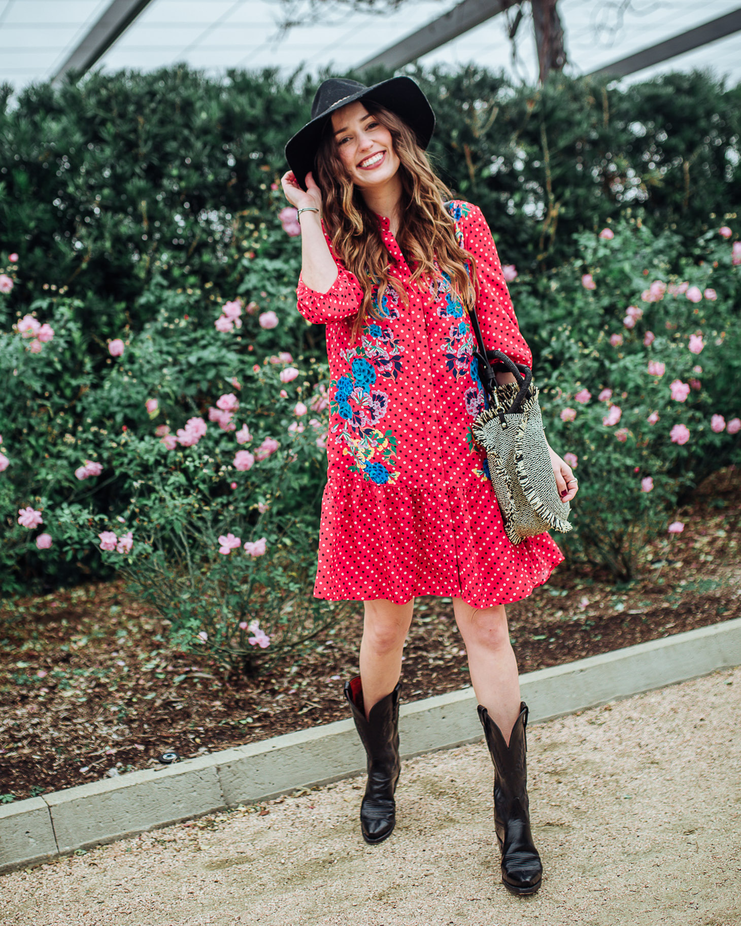 Cute Cowboy Boots roundup featured by top Houston fashion blog, Lone Star Looking Glass: image of a woman wearing Lucchese cowboy boots available at Zappos, a SALONI floral dress, Nordstrom Panama hat