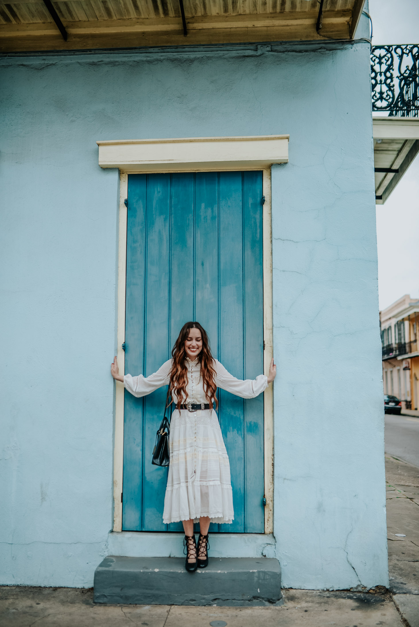 The perfect Boho White Dress for Spring styled by top US fashion blog, Lone Star Looking Glass: image of a woman wearing a Hanging Rock Gown boho white dress available at Shopbop, Free People studded belt, trench booties and an Anthropologie mini tote