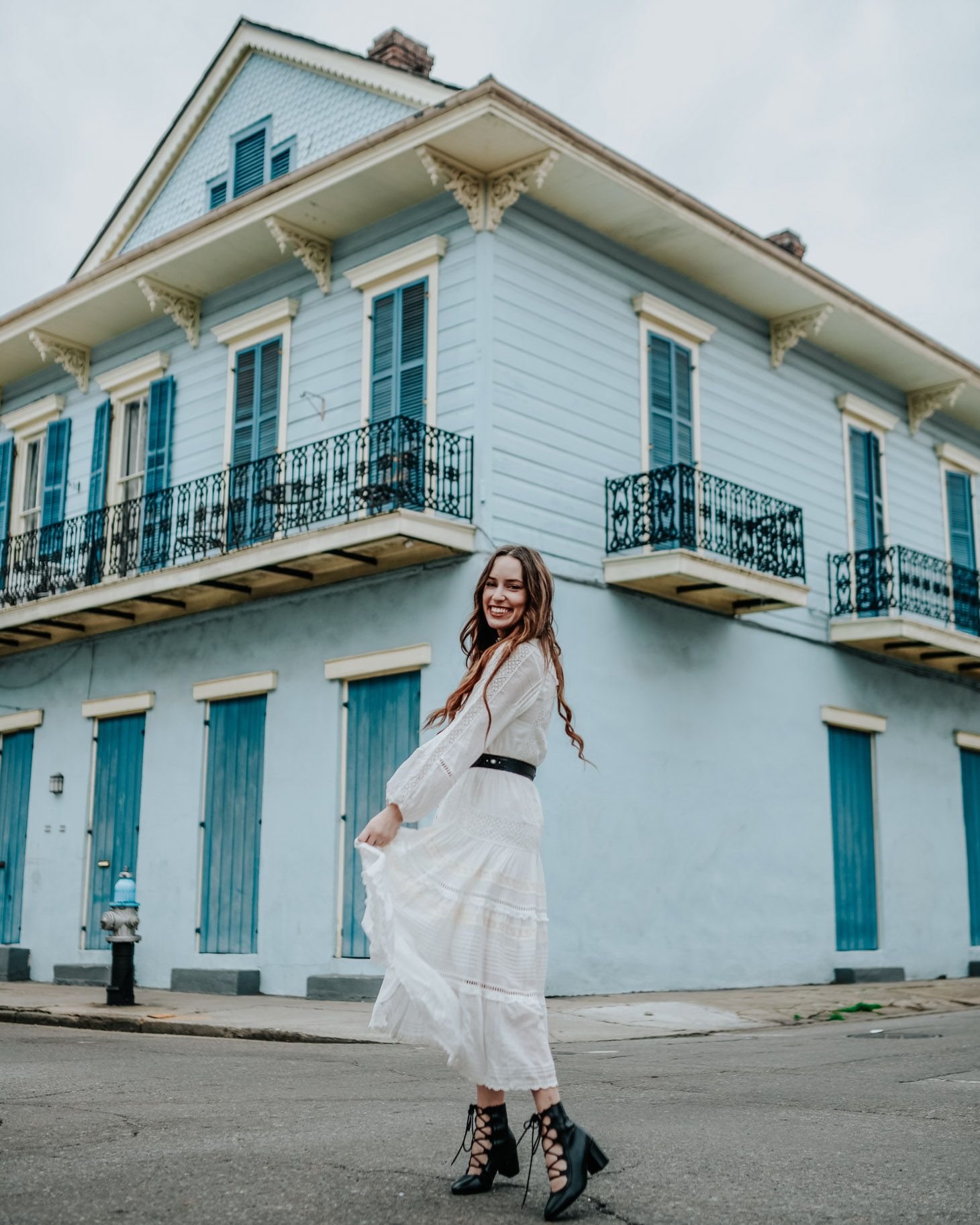 The perfect Boho White Dress for Spring styled by top US fashion blog, Lone Star Looking Glass: image of a woman wearing a Hanging Rock Gown boho white dress available at Shopbop, Free People studded belt, trench booties and an Anthropologie mini tote