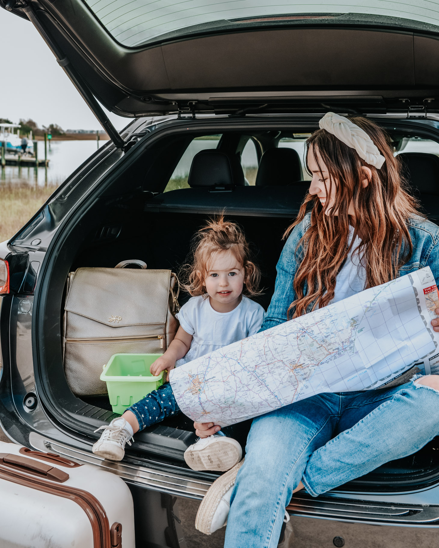 10 Essential Tips for your Next Road Trip with a Toddler featured by top US travel blog, Lone Star Looking Glass: image of a mom and toddler reading a road map