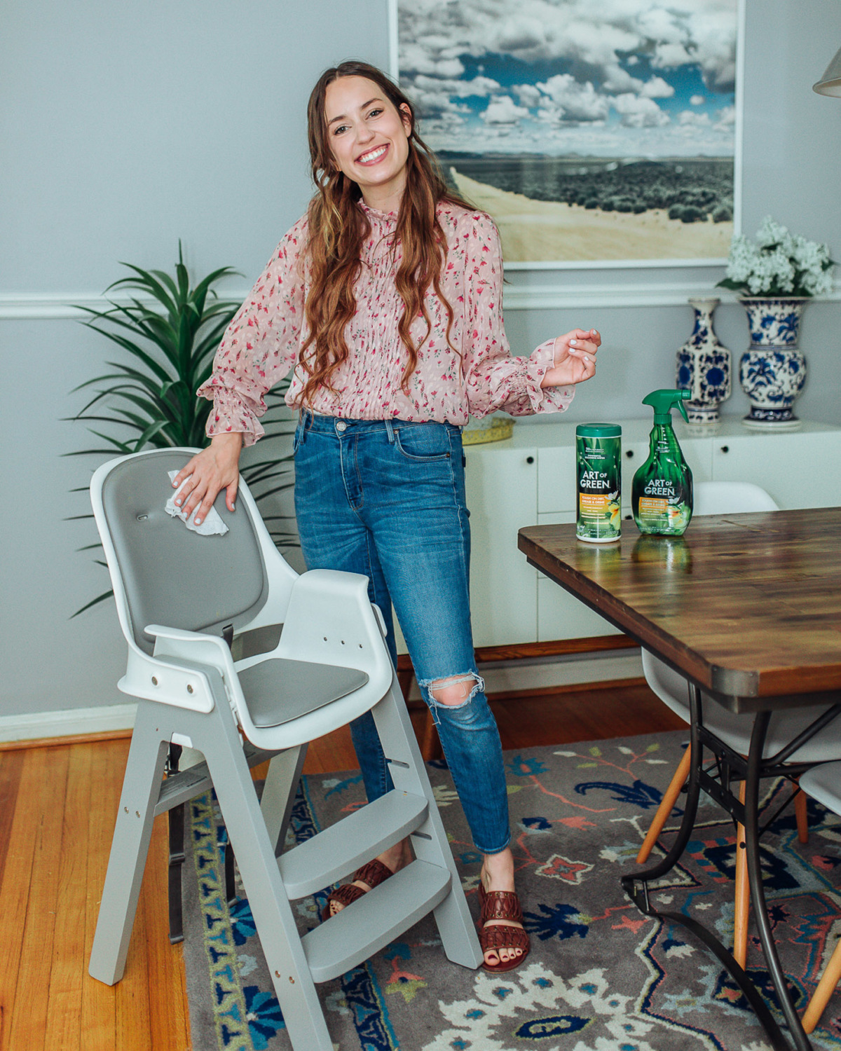 Essential Green Spring Cleaning Tips featured by top US lifestyle blog, Lone Star Looking Glass: image of a woman cleaning a toddler's high chair