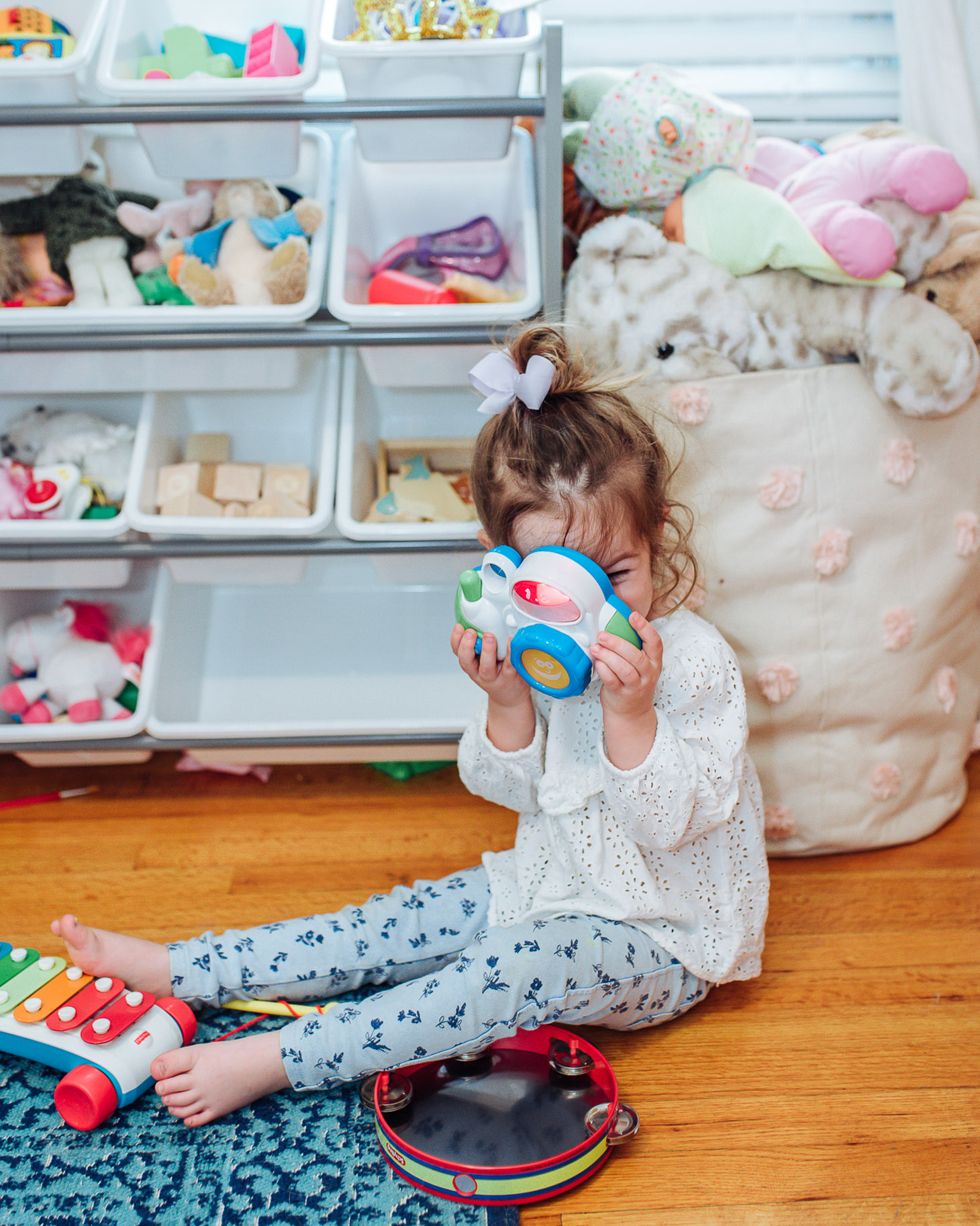 Essential Green Spring Cleaning Tips featured by top US lifestyle blog, Lone Star Looking Glass: image of a toddler playing with toys 
