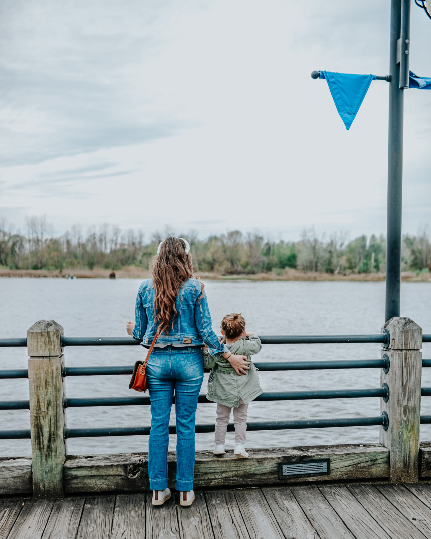 10 Essential Tips for your Next Road Trip with a Toddler featured by top US travel blog, Lone Star Looking Glass: image of a mom and toddler on a dock
