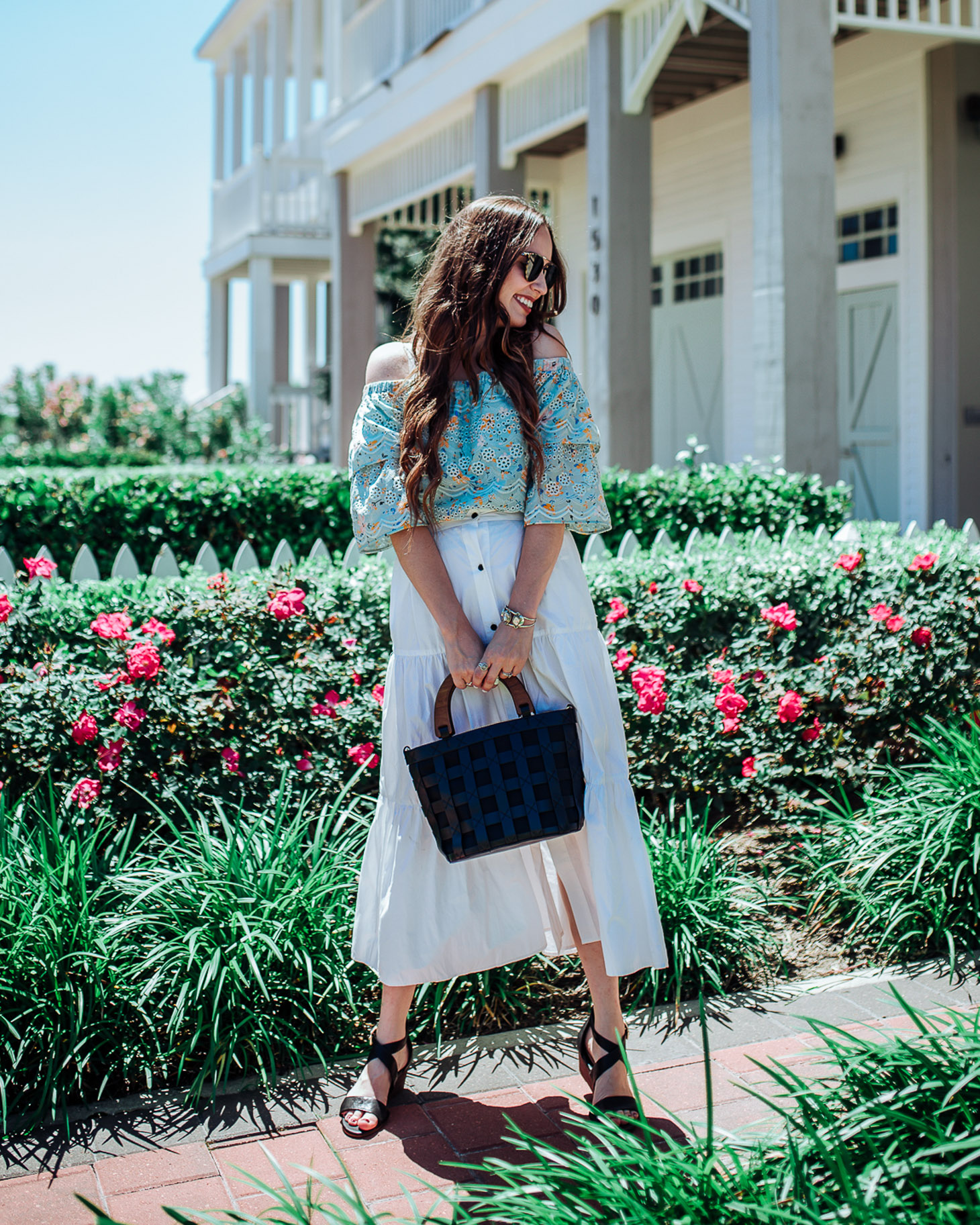 Stylish Platform Wedge Sandals for Summer featured by top US fashion blog, Lone Star Looking Glass: image of a woman wearing Solid & Striped long skirt, Anthropologie off the shoulder floral blouse, and Sofft platform wedge sandals
