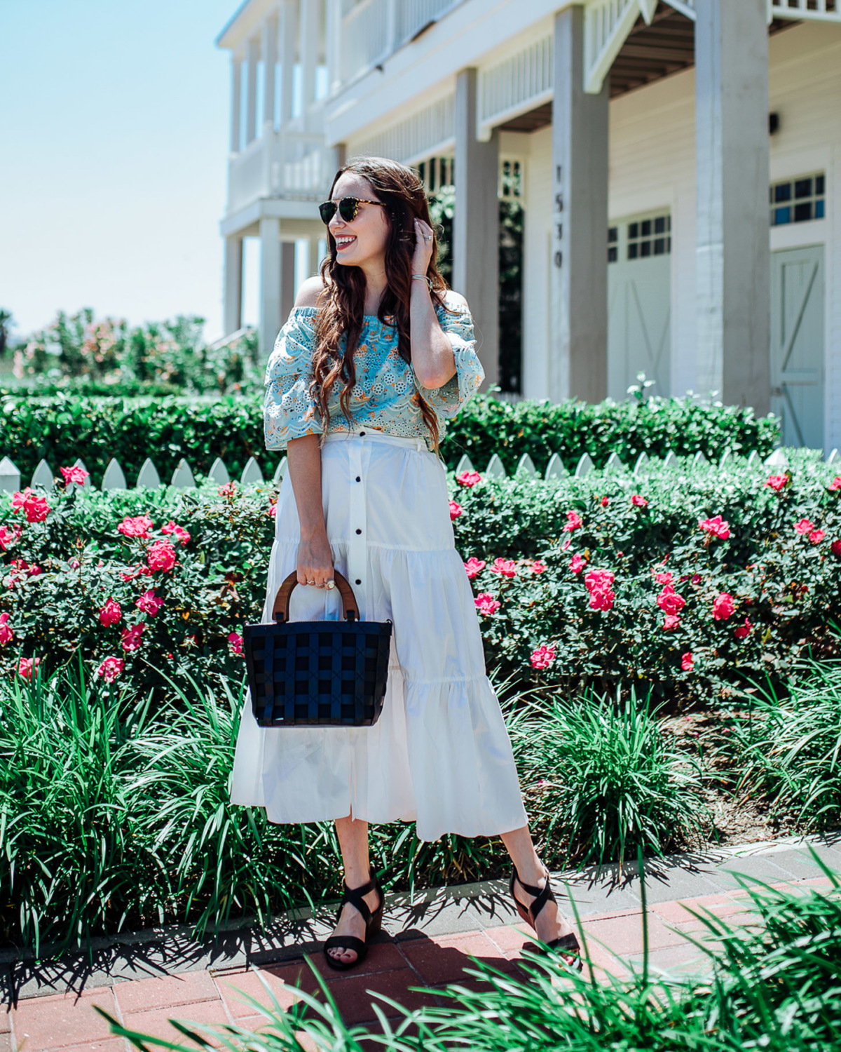 Stylish Platform Wedge Sandals for Summer featured by top US fashion blog, Lone Star Looking Glass: image of a woman wearing Solid & Striped long skirt, Anthropologie off the shoulder floral blouse, and Sofft platform wedge sandals