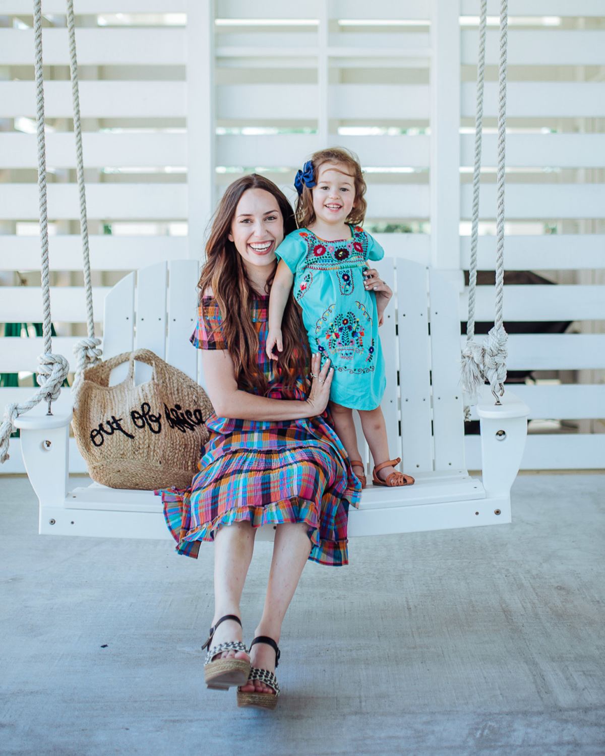 Francesca’s Sundress Outfits to wear for Mothers Day, featured by top US fashion blog, Lone Star Looking Glass: image of a woman wearing a Francesca’s plaid over the shoulder dress, wedge heels and a shopper jute tote
