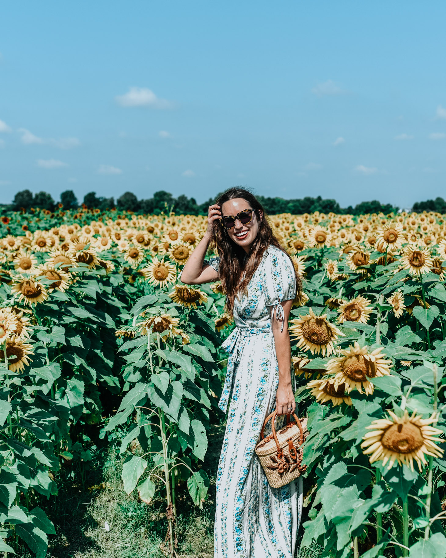 5 Dress Designers to Take Note Of this Summer by popular Memphis fashion blog, Lone Star Looking Glass: image of a woman standing in a sunflower field and wearing a Gal Meets Glam Dress.