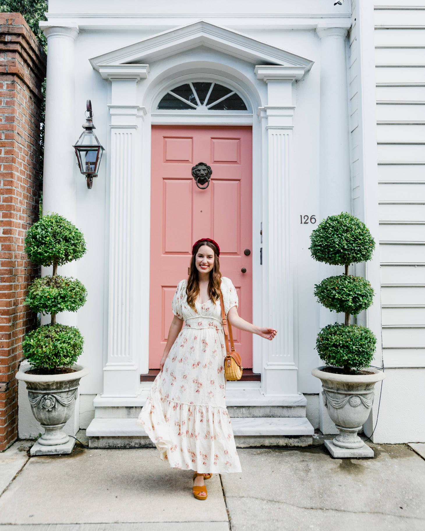 The New Southern Living Tastemaker, featured by top US life and style blog, Lone Star Looking Glass: image of a woman wearing a LoveShackFancy floral maxi dress, Patricia Nash leather sandals, velvet headband, and a Poolside Le Cercle crossbody tote.