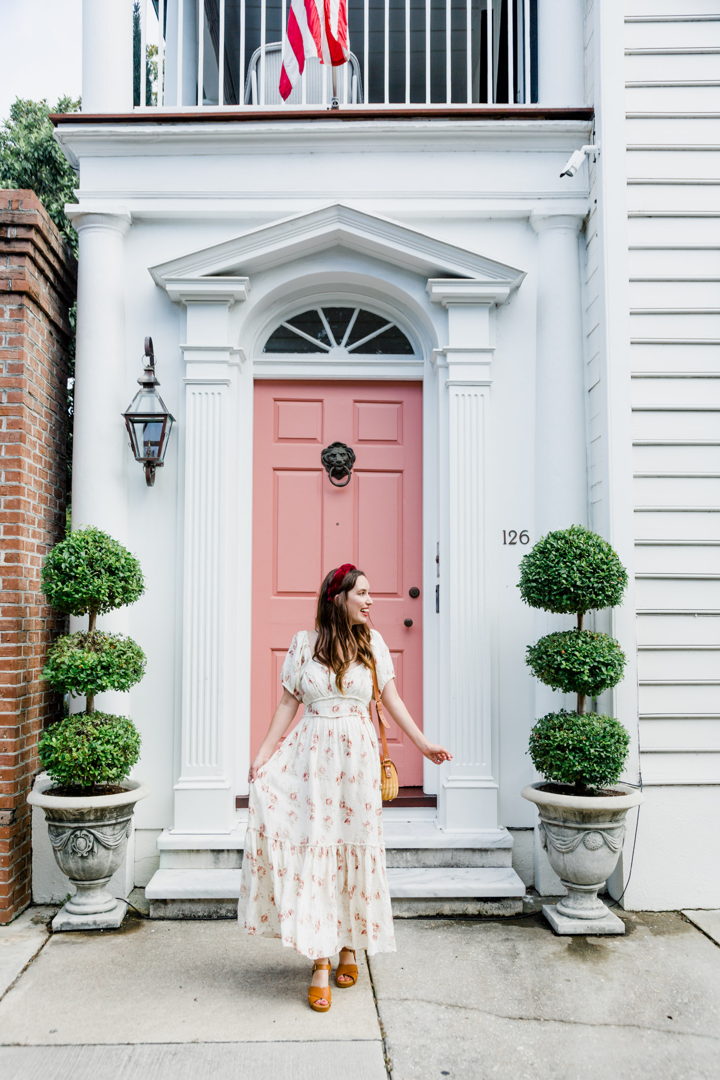 The New Southern Living Tastemaker, featured by top US life and style blog, Lone Star Looking Glass: image of a woman wearing a LoveShackFancy floral maxi dress, Patricia Nash leather sandals, velvet headband, and a Poolside Le Cercle crossbody tote.