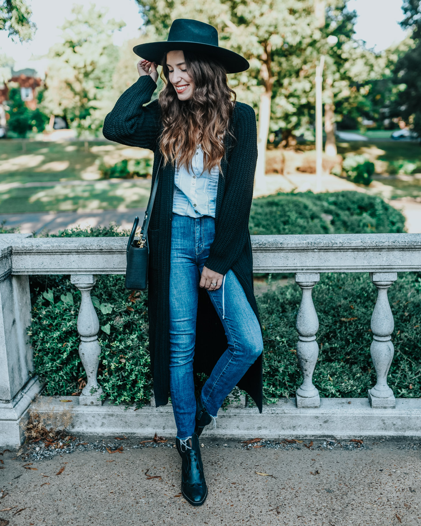 Cute fall cardigans featured by top US fashion blog, Lone Star Looking Glass: image of a woman wearing a Revolve long black fall cardigan, Anthropologie lace blouse, Kelsi Dagger Brooklyn booties, Mother fray jeans, and a Revolve Panama hat.