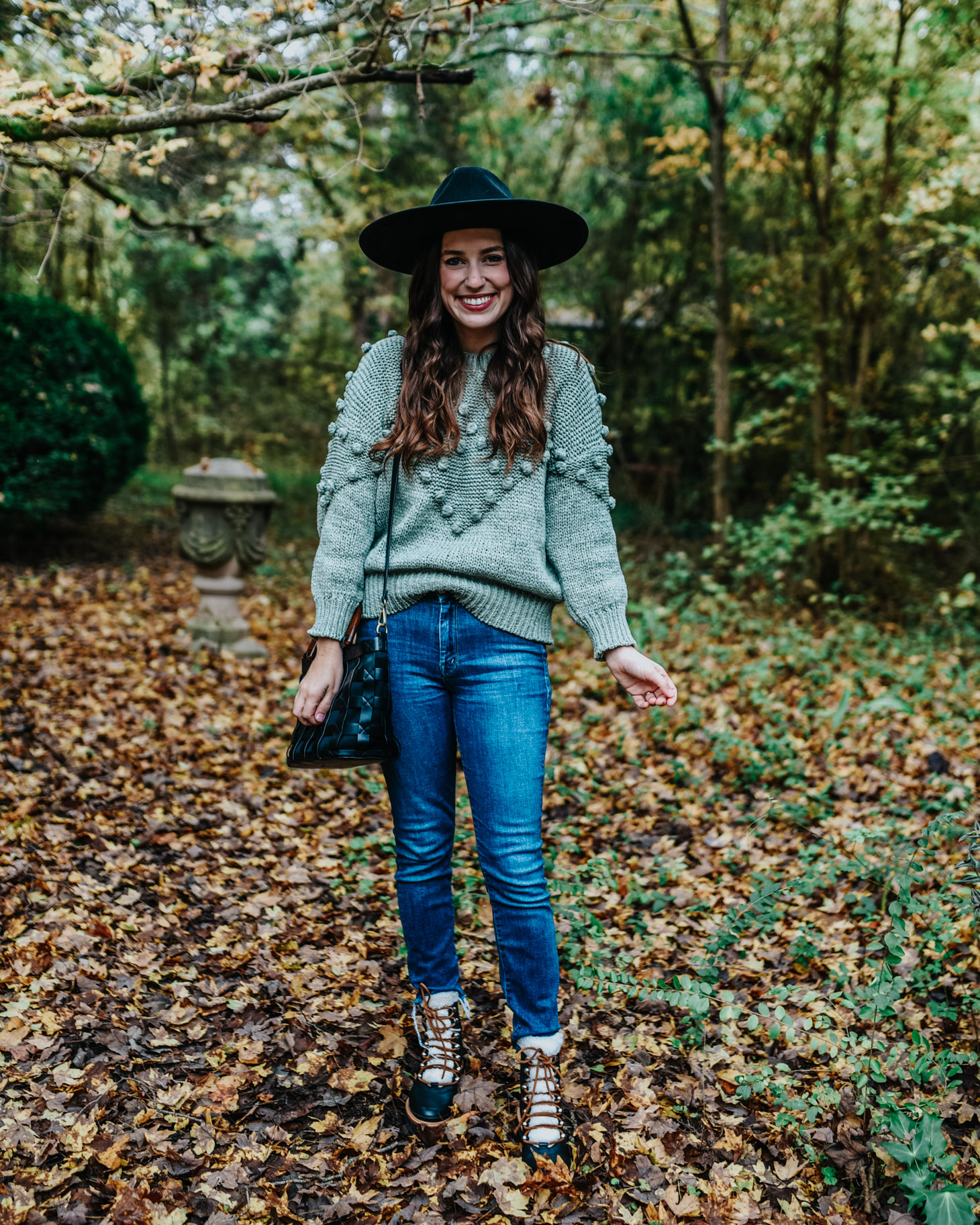 Fall Trends: Pom Pom Sweaters + Combat Boots by popular fashion blog, Lone Star Looking Glass: image of a woman outside wearing a Chicwish Pom-Pom Trim Chunky Knit Sweater in Green and MARC FISHER LTD Izzie Lugsole Ankle Boots. 