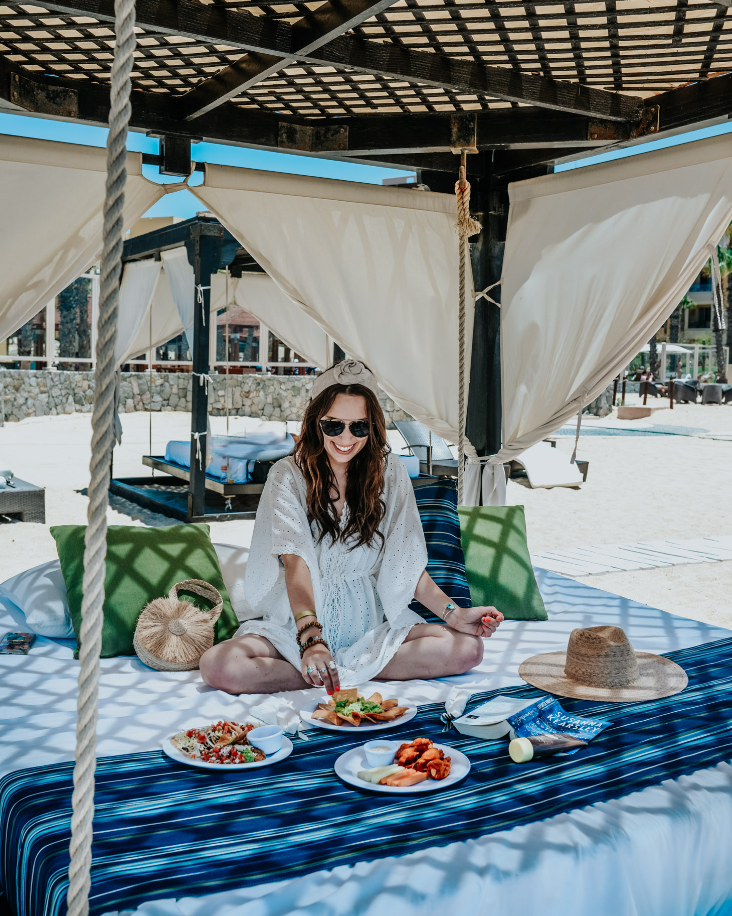 Pueblo Bonito Pacifica: 8 Reasons to Vacation in Cabo by popular Tennessee travel blog, Lone Star Looking Glass: image of a woman sitting in a beach cabana and eating chips and guacamole. 