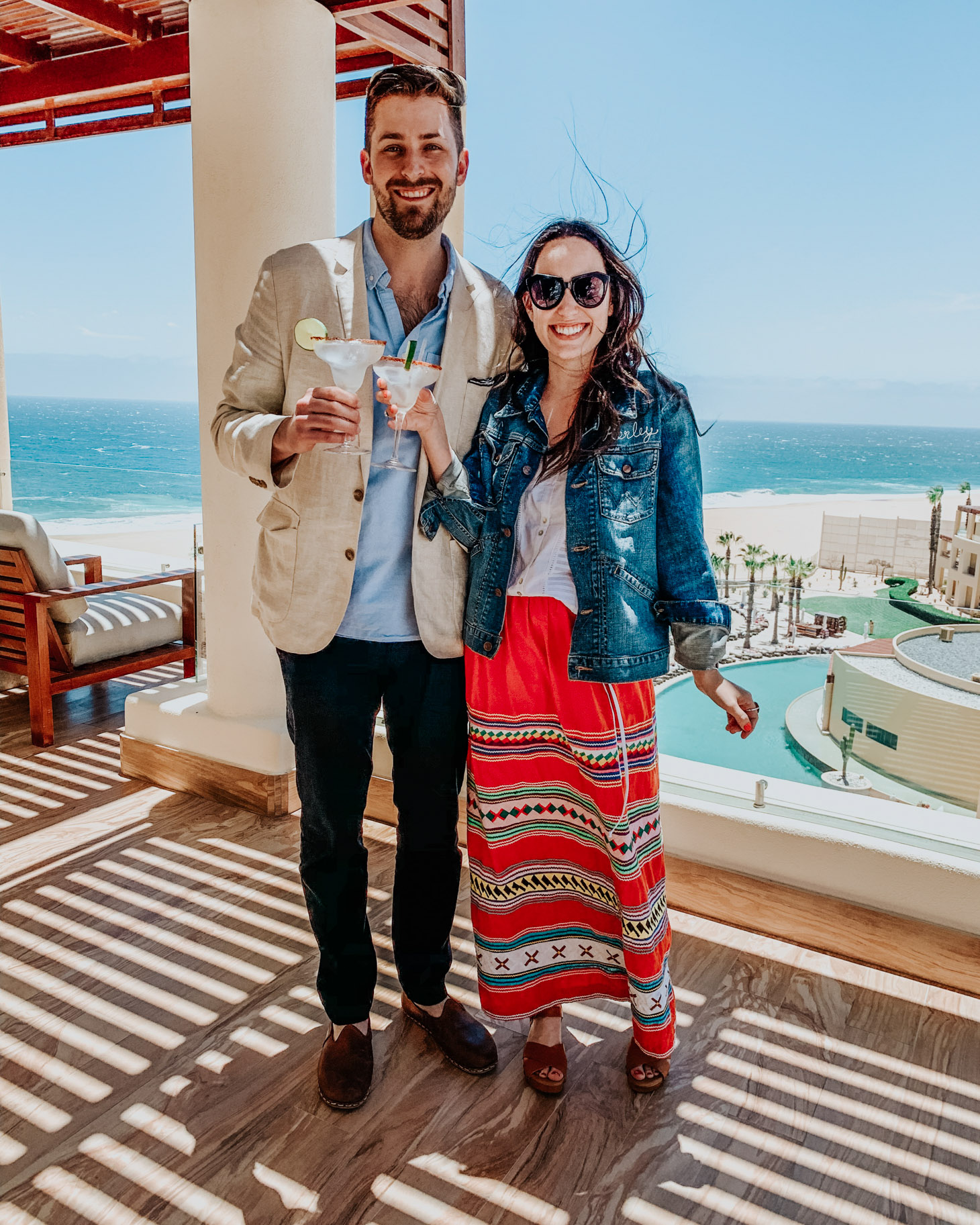 Pueblo Bonito Pacifica: 8 Reasons to Vacation in Cabo by popular Tennessee travel blog, Lone Star Looking Glass: image of a couple holding margaritas at the Pueblo Bonita Pacifica. 