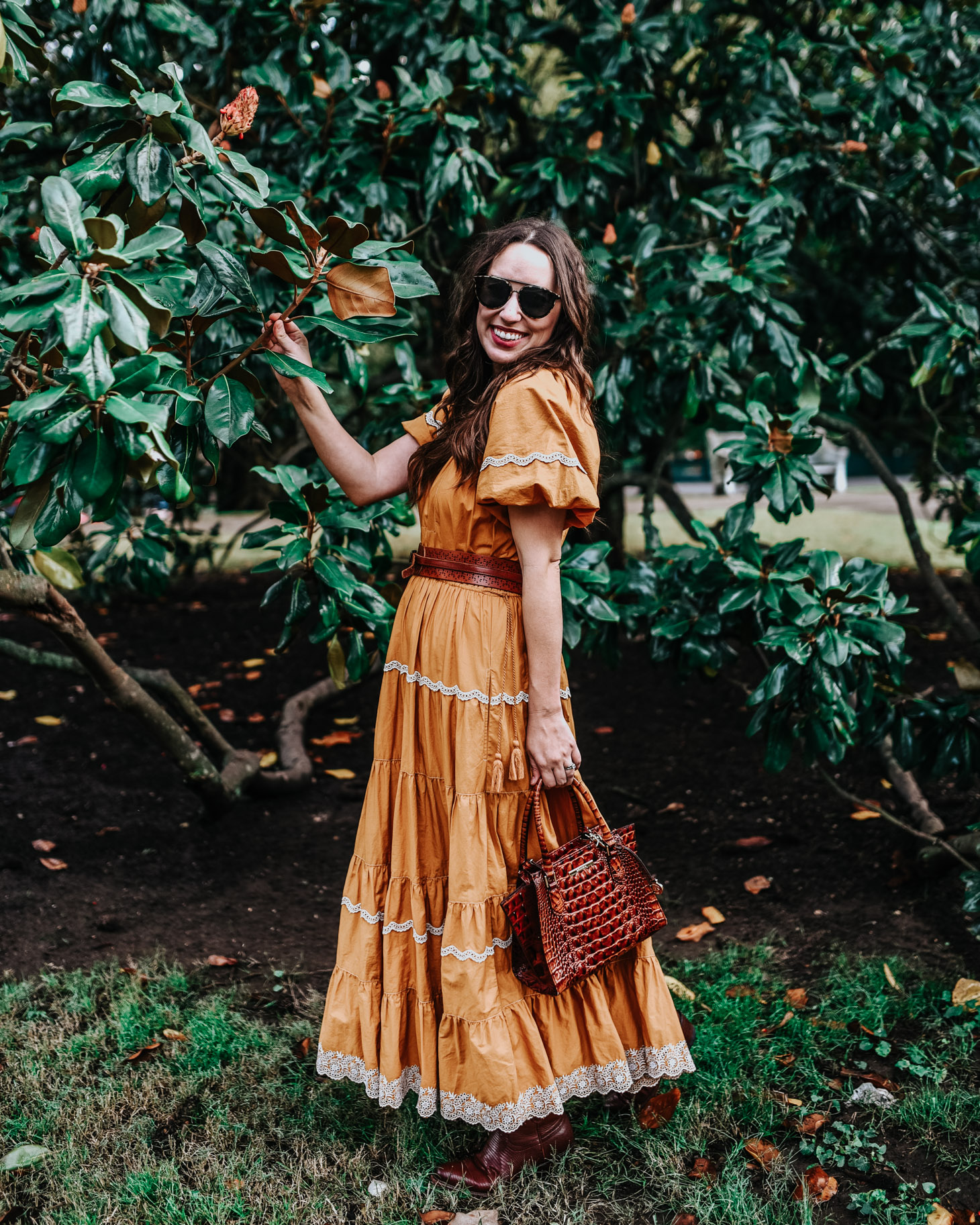 Tennessee Fashion Blogger styles Yellow Ulla Johnson Dress with Tecovas Boots | A Bold Yellow Maxi Dress for Fall by Popular Tennessee fashion blog, Lone Star Looking Glass: image of a woman standing outside and wearing a Ulla Johnson Claribel Dress.