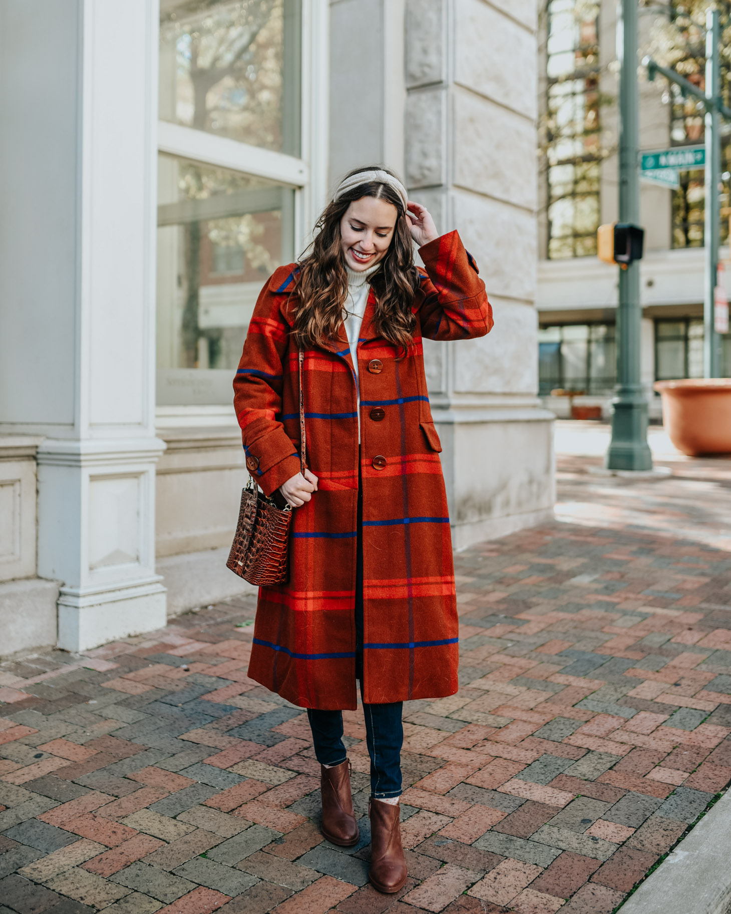 Plaid winter coats featured by top US fashion blog, Lone Star Looking Glass: image of a woman wearing an Anthropologie red plaid winter coat.