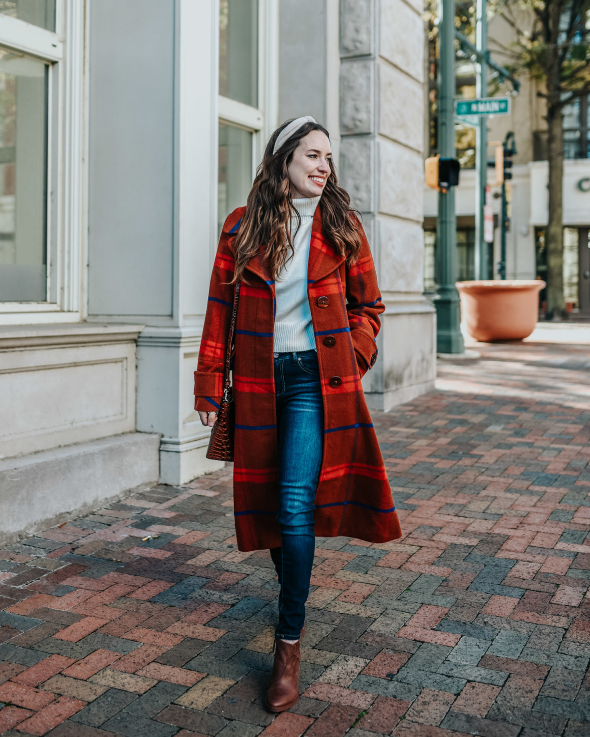 Plaid winter coats featured by top US fashion blog, Lone Star Looking Glass: image of a woman wearing an Anthropologie red plaid winter coat.