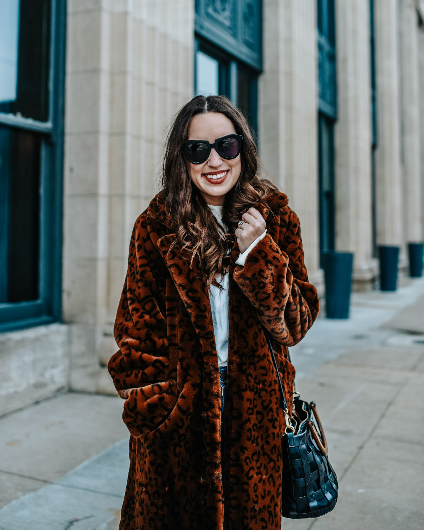 Luxe leopard coat styled down by top US fashion blog, Lone Star Looking Glass: image of a woman wearing a Revolve luxe leopard coat, Golden Goose sneakers and skinny jeans.