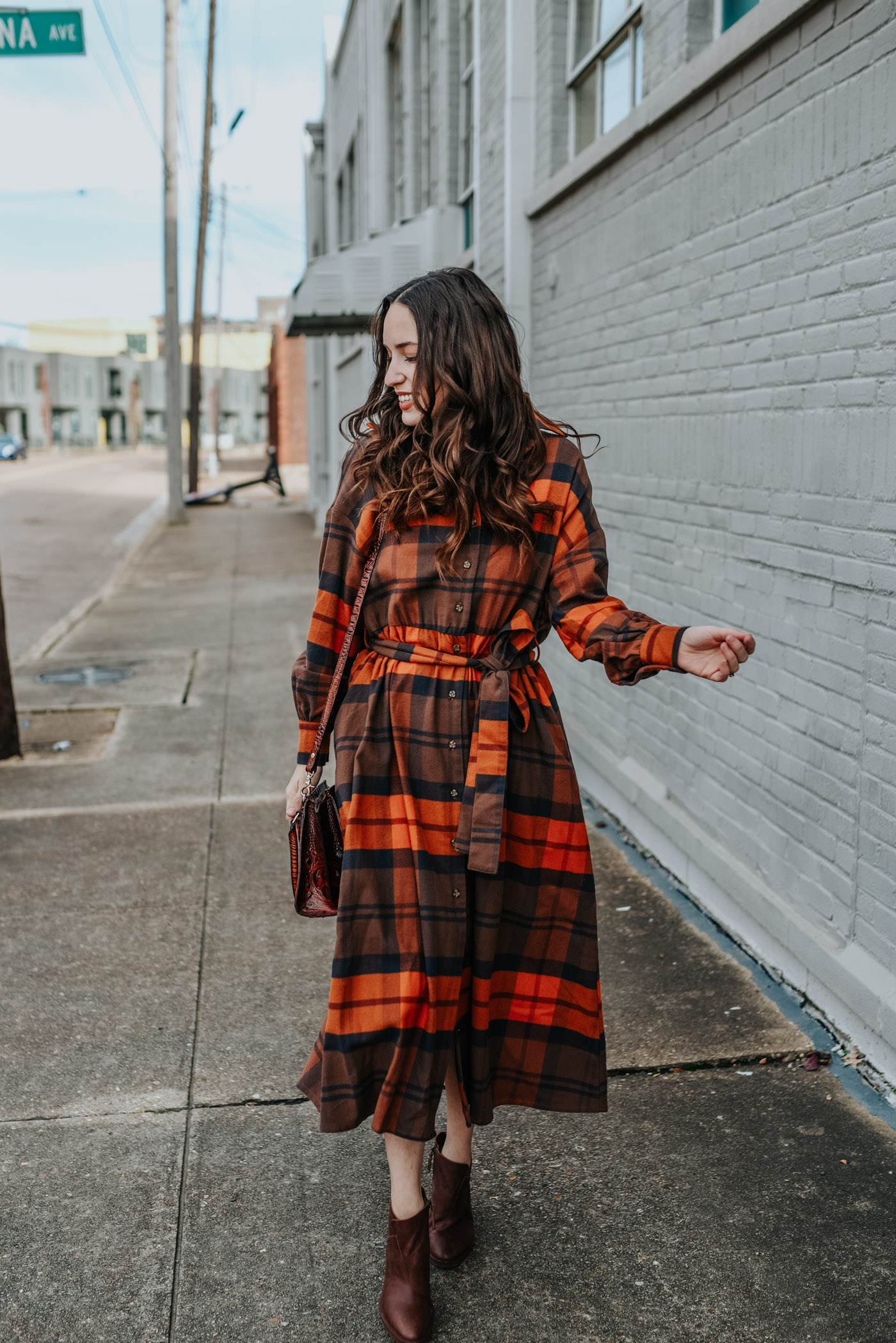 A Pretty (Warm) Plaid Shirt Dress by popular Tennessee fashion blog, Lone Star Looking Glass: image of a woman outside wearing an orange Nuuly Checkered Shirtdress.