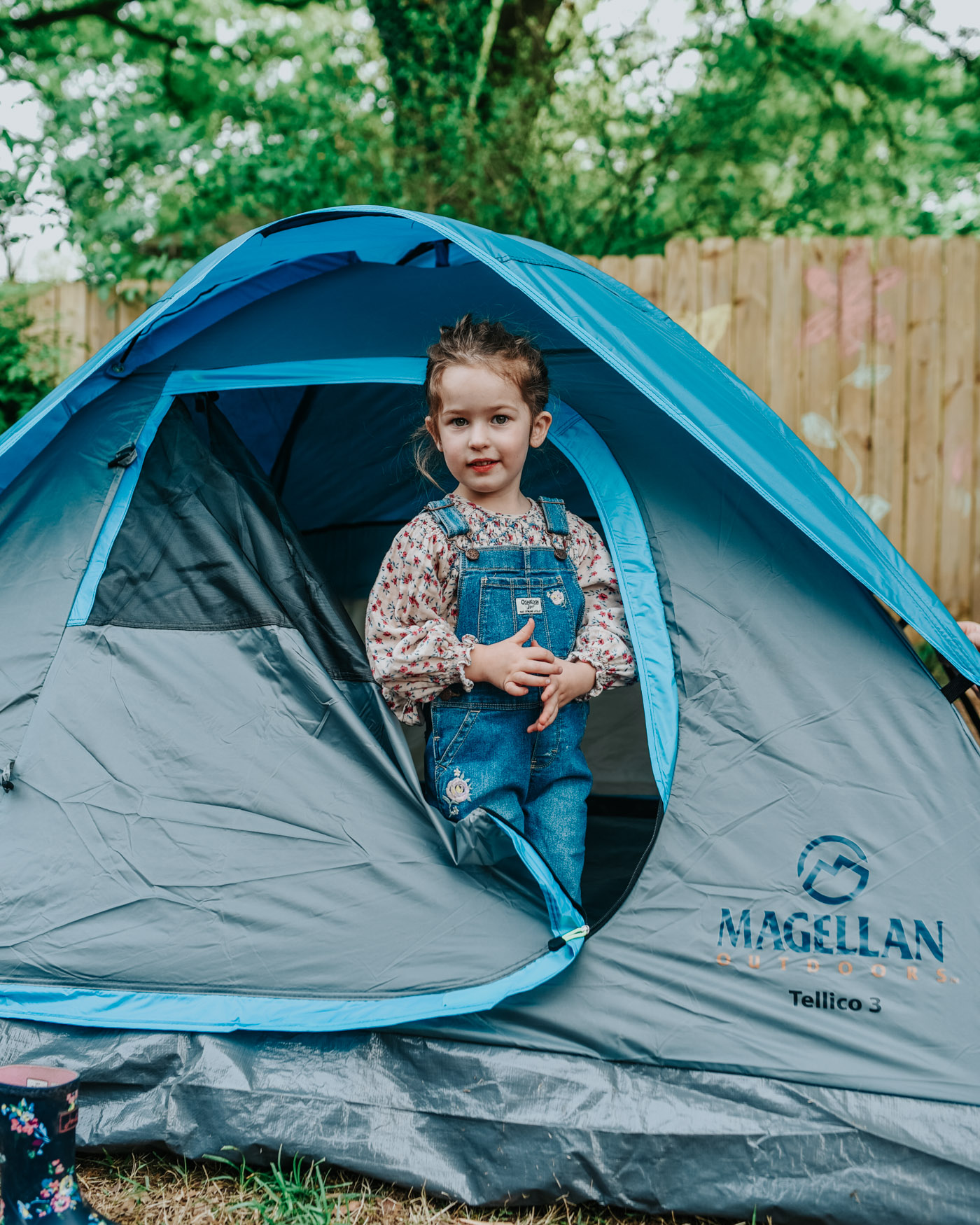 Backyard Camping by popular Memphis lifestyle blog, Lone Star Looking Glass: image of a little girl standing inside a Academy Magellan Outdoors Tellico 3 Person Dome Tent.