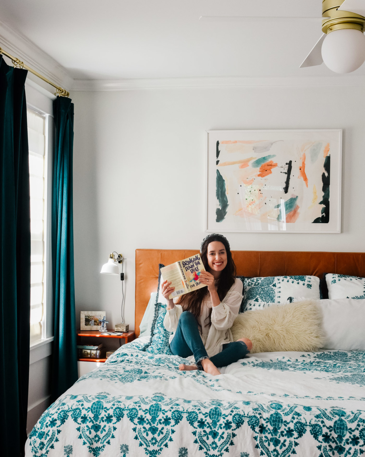modern bohemian bedroom decor. anthropologie teal bedding, anthropologie teal curtains, article leather headboard, minted art bedroom