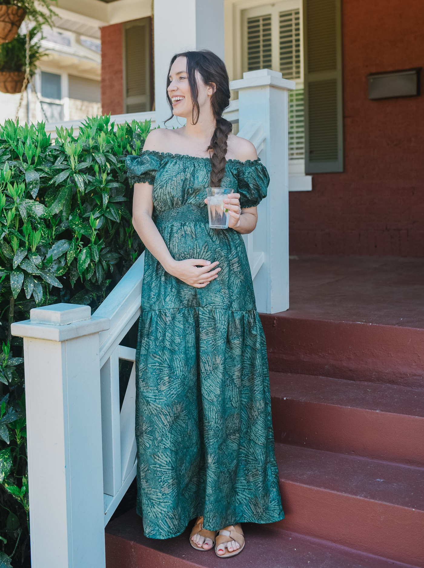 Hunter Fan Company Memphis TN by popular Memphis life and style blog, Lone Star Looking Glass: image of a woman standing on her front porch and wearing a Free People Nuuly green off the shoulder maxi dress.