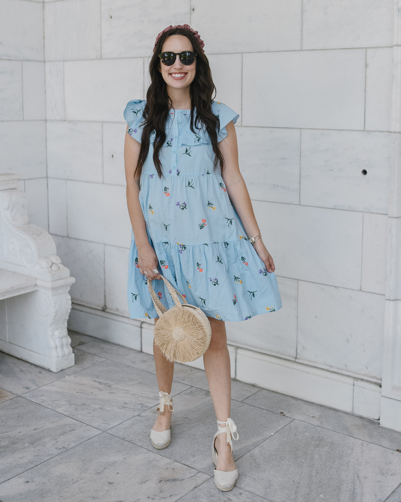 Embroidered Dress by popular Memphis fashion blog, Lone Star Looking Glass: image of a woman wearing some tortoiseshell frame sunglasses, a pink headband, Soludos Mallorca Wedges, Gal Meets Glam blue embroidered dress, and holding a straw circle bag. 