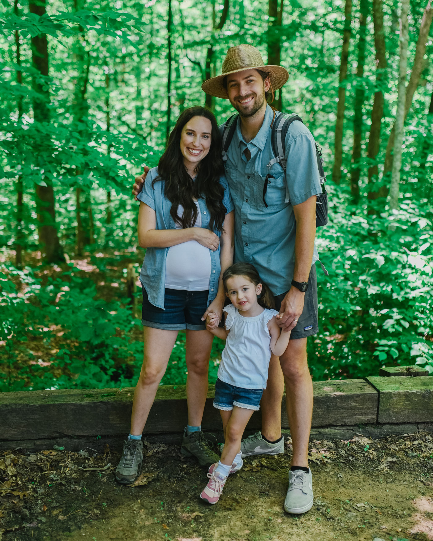 Father's Day Gift Ideas by popular Memphis lifestyle blog, Lone Star Looking Glass: image of a mom, dad, and their young daughter standing together in a forest. 