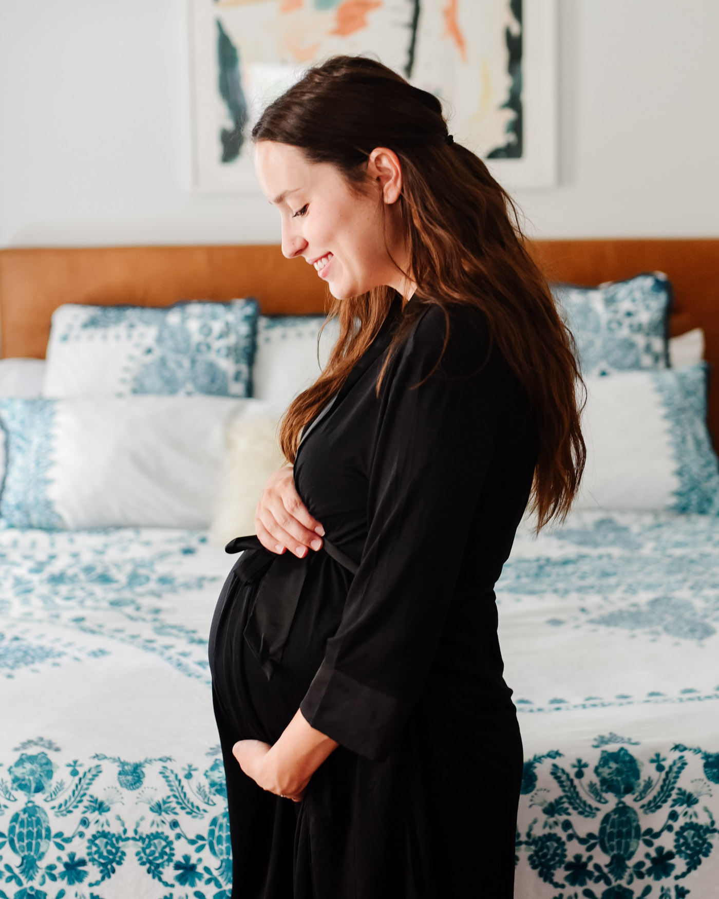 Maternity Pajamas by popular Memphis fashion blog, Lone Star Looking Glass: image of a woman placing her hands on her pregnant belly and wearing a Kindread Bravely Emmaline Robe. 