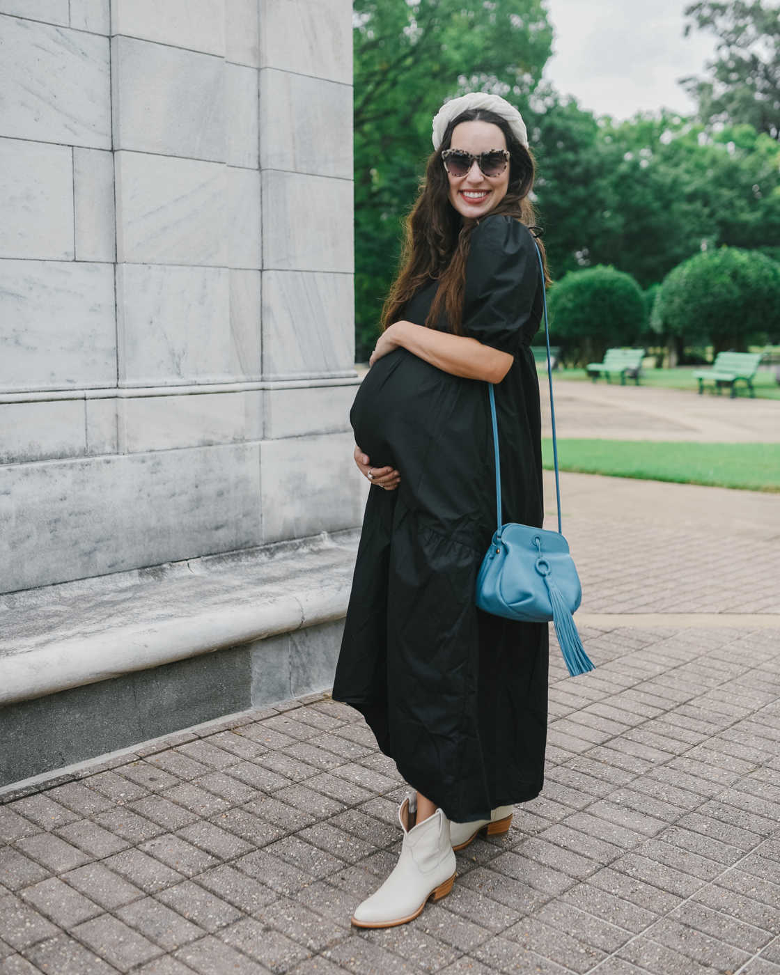 White Cowboy Boots by popular Memphis fashion blog, Lone Star Looking Glass: image of a woman standing outside and wearing a black puff sleeve maxi dress, Amazon Velvet Braided Flock Padded Headband, Hobo BIRDY Crossbody, and white cowboy boots. 