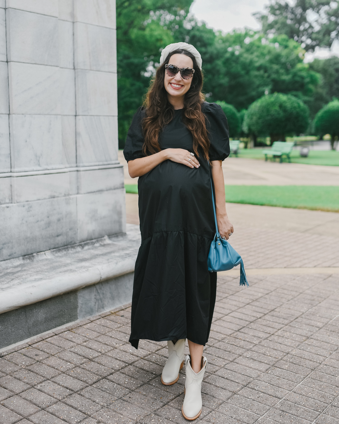 White Cowboy Boots by popular Memphis fashion blog, Lone Star Looking Glass: image of a woman standing outside and wearing a black puff sleeve maxi dress, Amazon Velvet Braided Flock Padded Headband, Hobo BIRDY Crossbody, and white cowboy boots. 