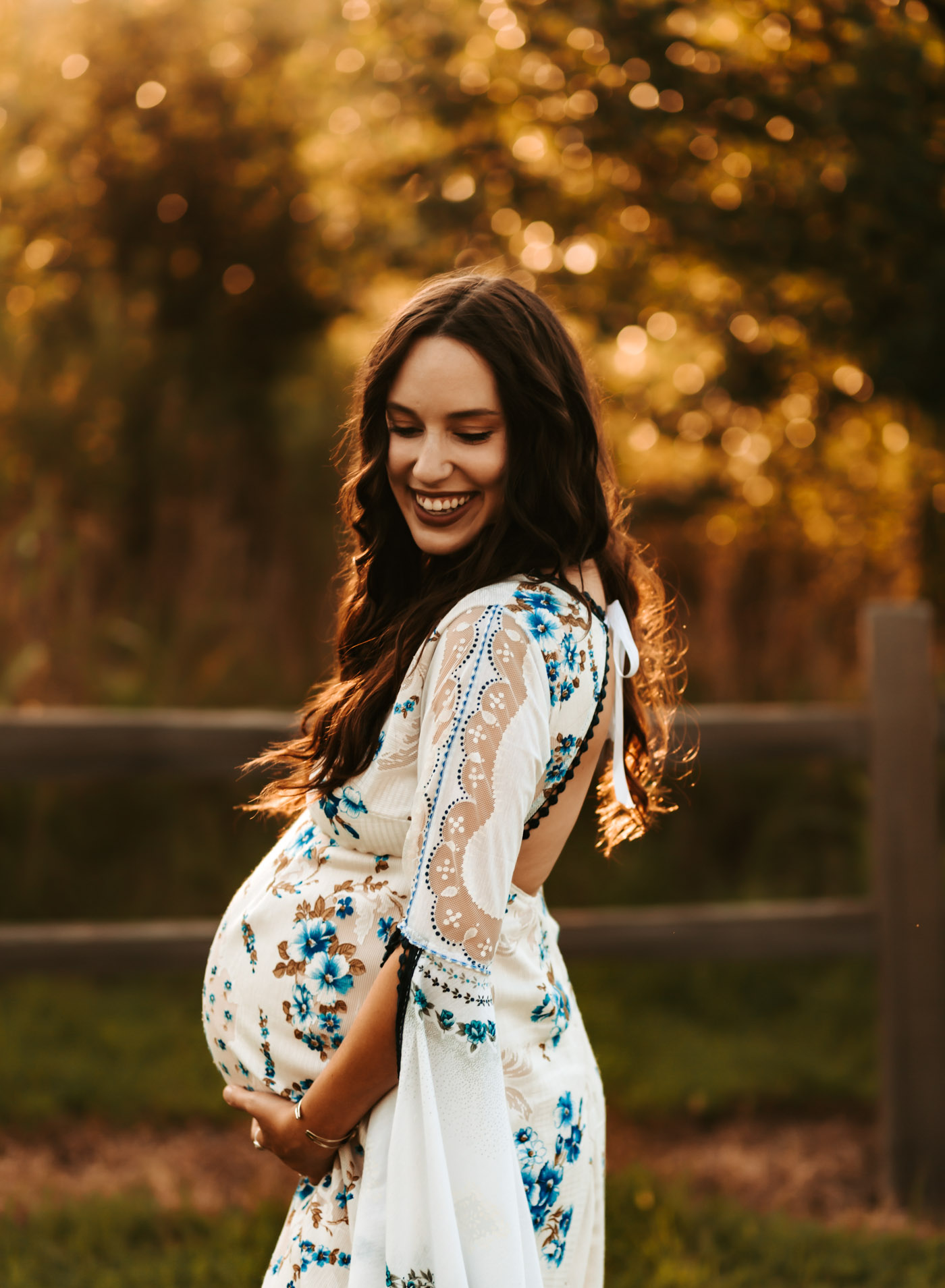 Maternity Photos by popular Memphis motherhood blog, Lone Star Looking Glass: image of a woman standing outside and wearing a Etsy The Traveling Dress Emily Boho Maternity Dress and Free People Western Cuff Set.