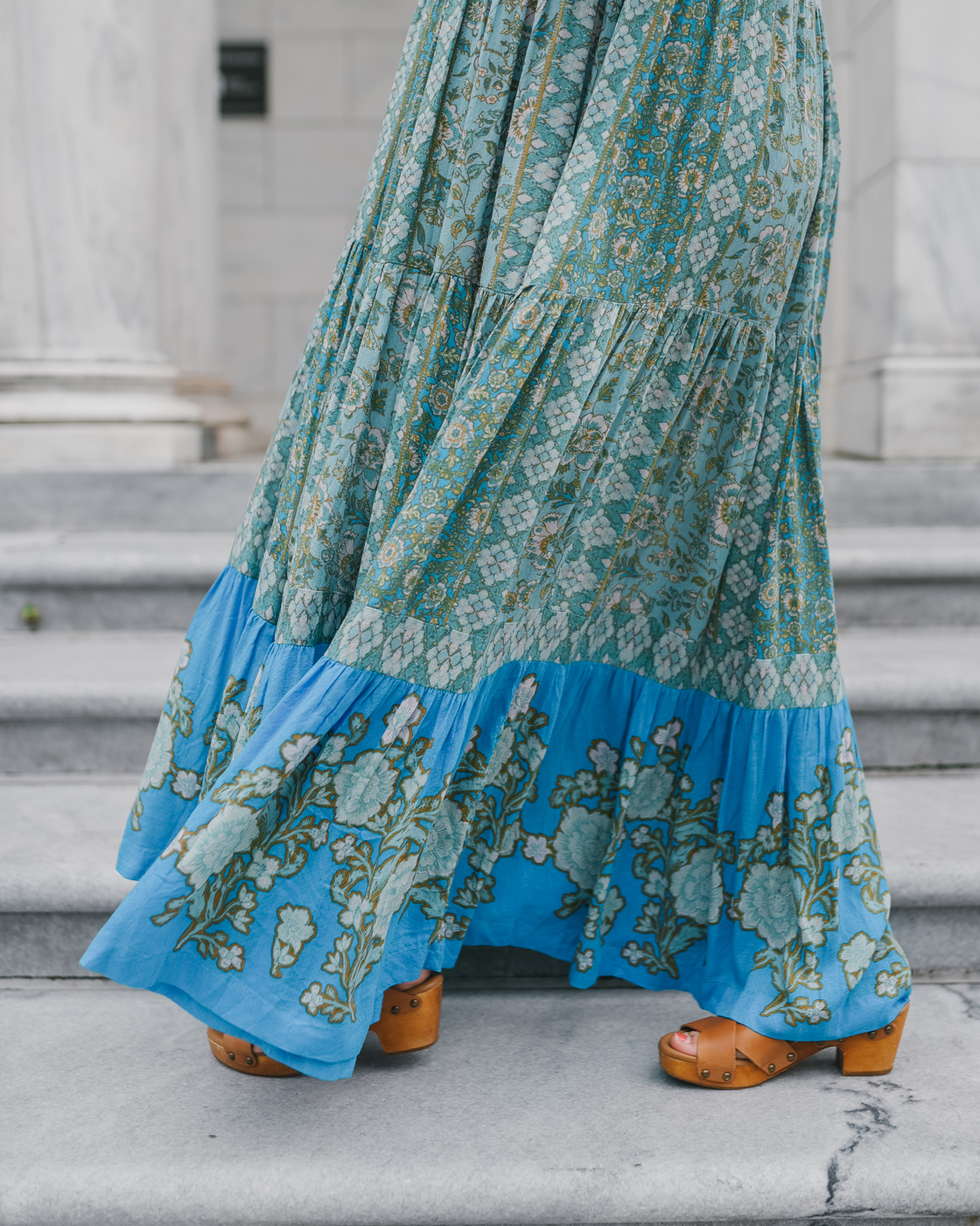 Bohemian Maxi Dresses by popular Memphis fashion blog, Lone Star Looking Glass: image of a woman standing on some grey marble steps outside and wearing a Free People Western Cuff Set, Free People Hanalei Bay Dress, and Zappos Swedish Hasbeens Kringlan. 