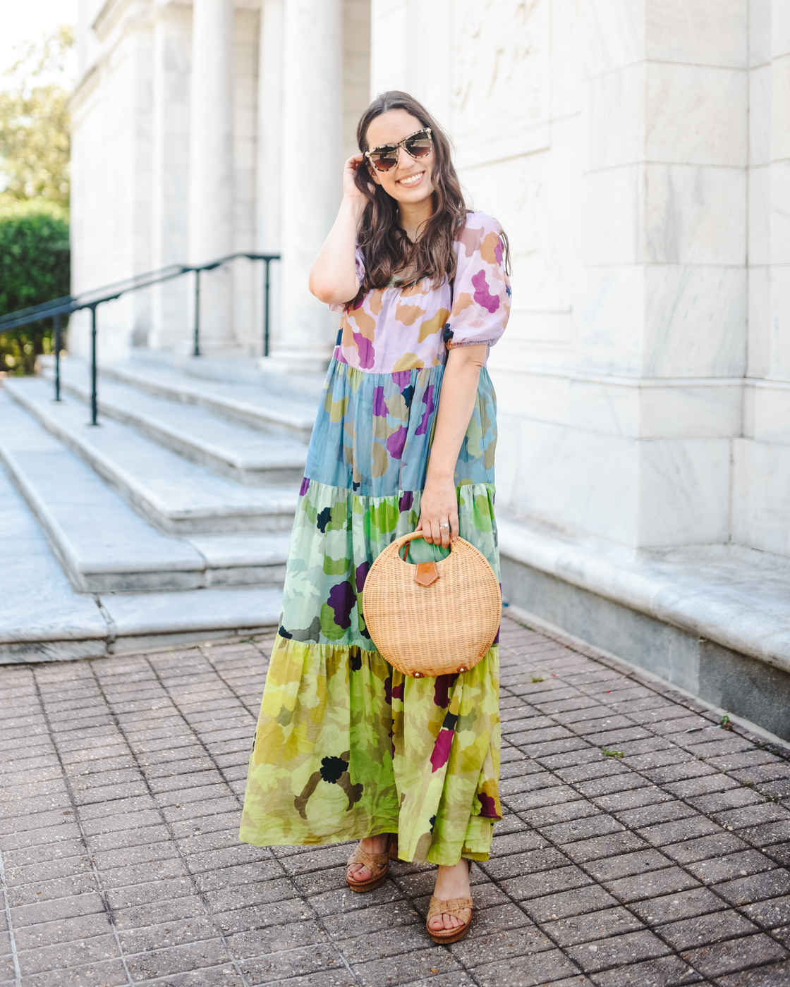 Tiered Maxi Dress by popular Memphis fashion blog, Lone Star Looking Glass: image of a woman wearing floral tiered maxi dress, tan block heel sandals, tortoise shell frame sunglasses, and holding a wicker handbag. 