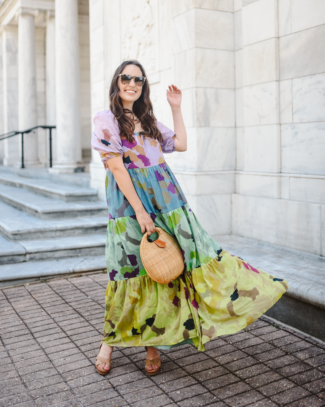 Tiered Maxi Dress by popular Memphis fashion blog, Lone Star Looking Glass: image of a woman wearing floral tiered maxi dress, tan block heel sandals, tortoise shell frame sunglasses, and holding a wicker handbag. 