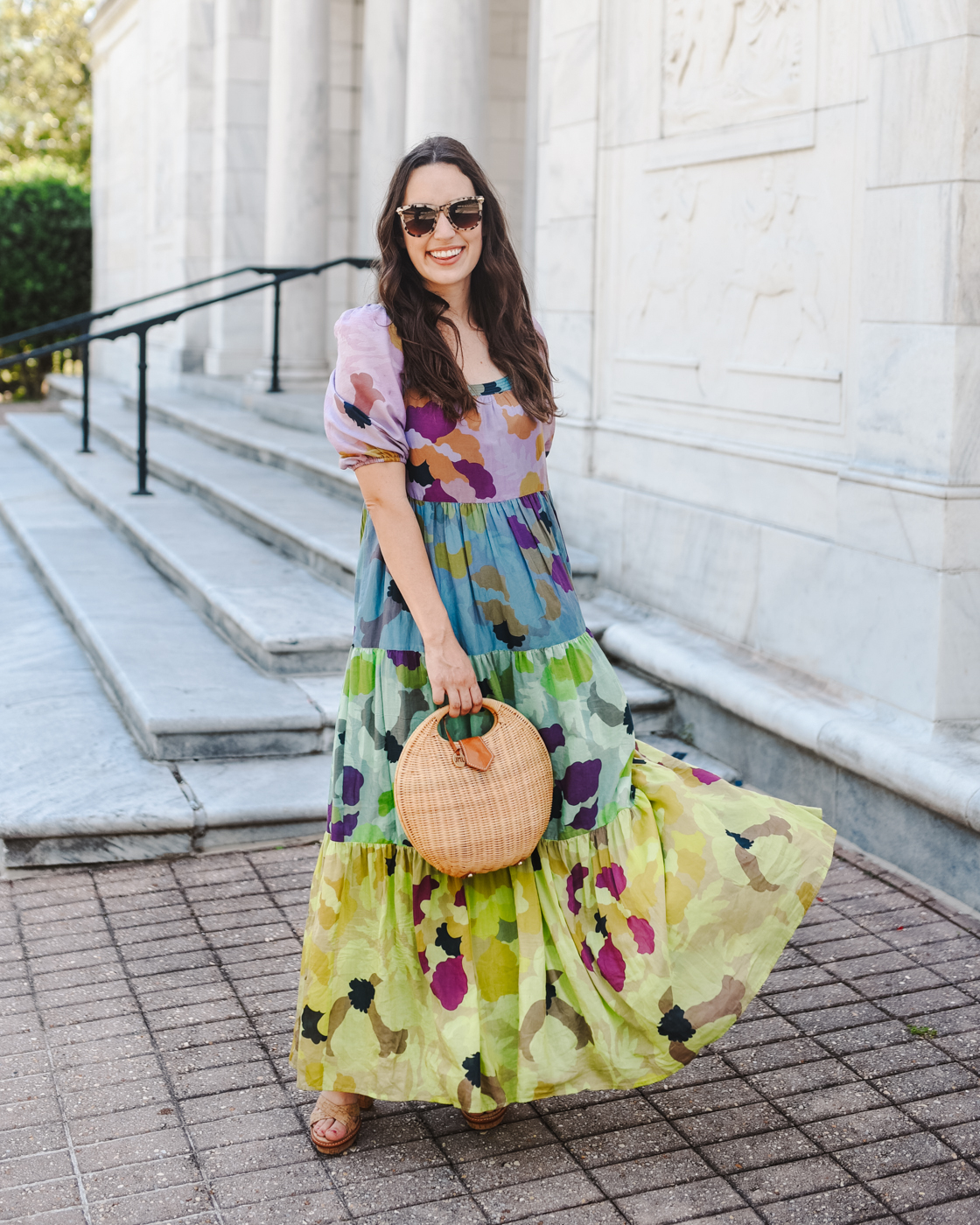 Tiered Maxi Dress by popular Memphis fashion blog, Lone Star Looking Glass: image of a woman wearing floral tiered maxi dress, tan block heel sandals, tortoise shell frame sunglasses, and holding a wicker handbag. 