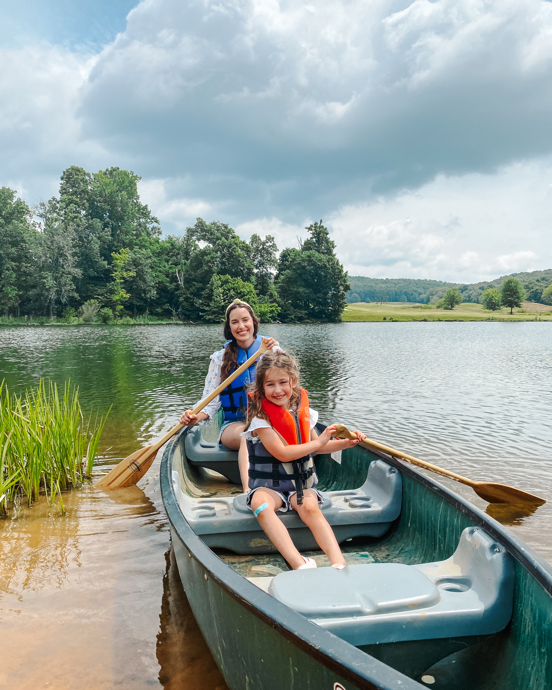 Barnsley Resort by popular Memphis travel blog, Lone Star Looking Glass: image of a mom and her daughter in a green canoe on a lake. 