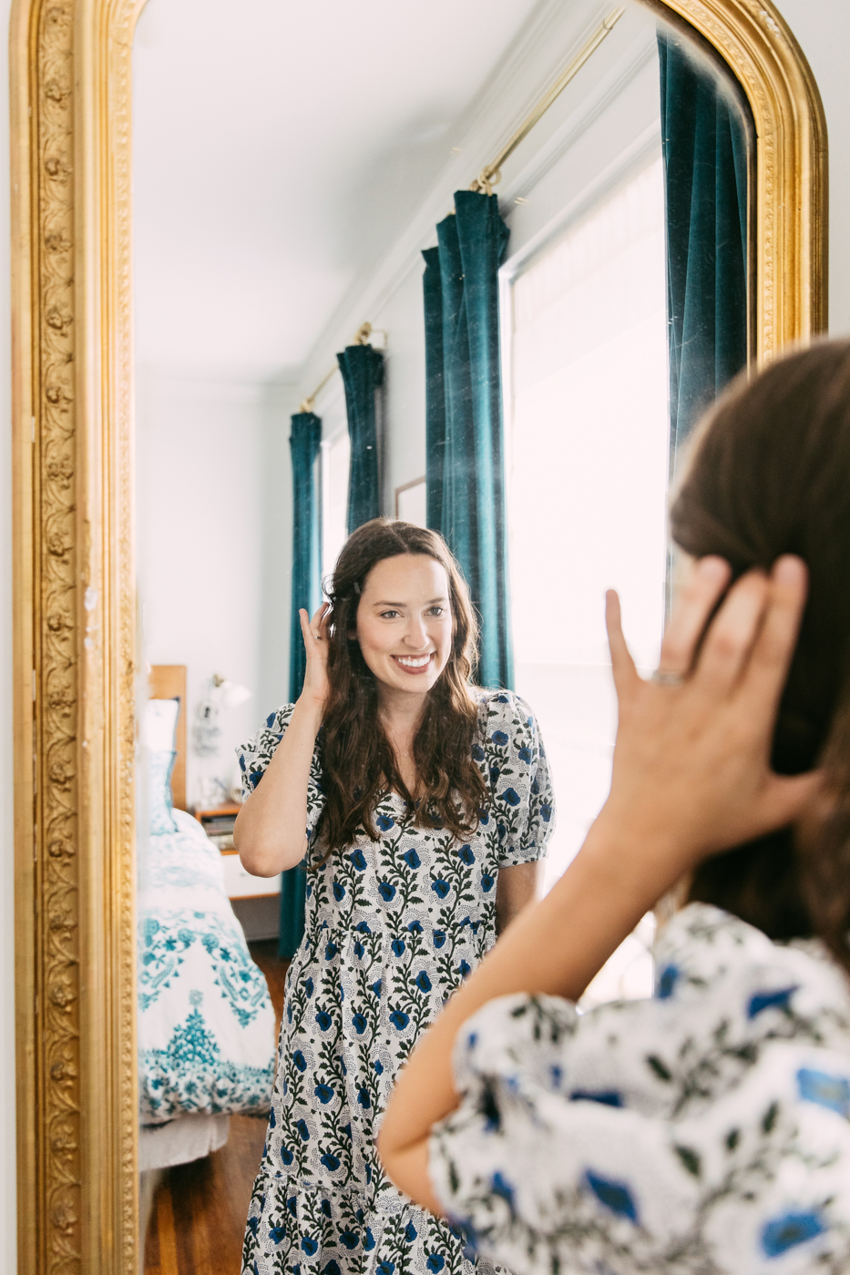 Antique Pier Mirror by popular Memphis life and style blog, Lone Star Looking Glass: image of a woman wearing a blue, grey and white floral maxi dress and looking at herself in a antique pier mirror. 