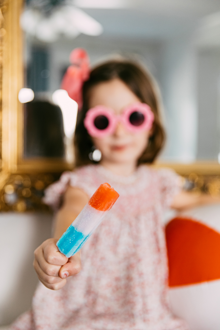 Lux Kono Smart Thermostat by popular Memphis lifestyle blog: image of a little girl wearing a pink dress, pink hair bow and pink flower frame sunglasses and holding a rocket popsicle. 