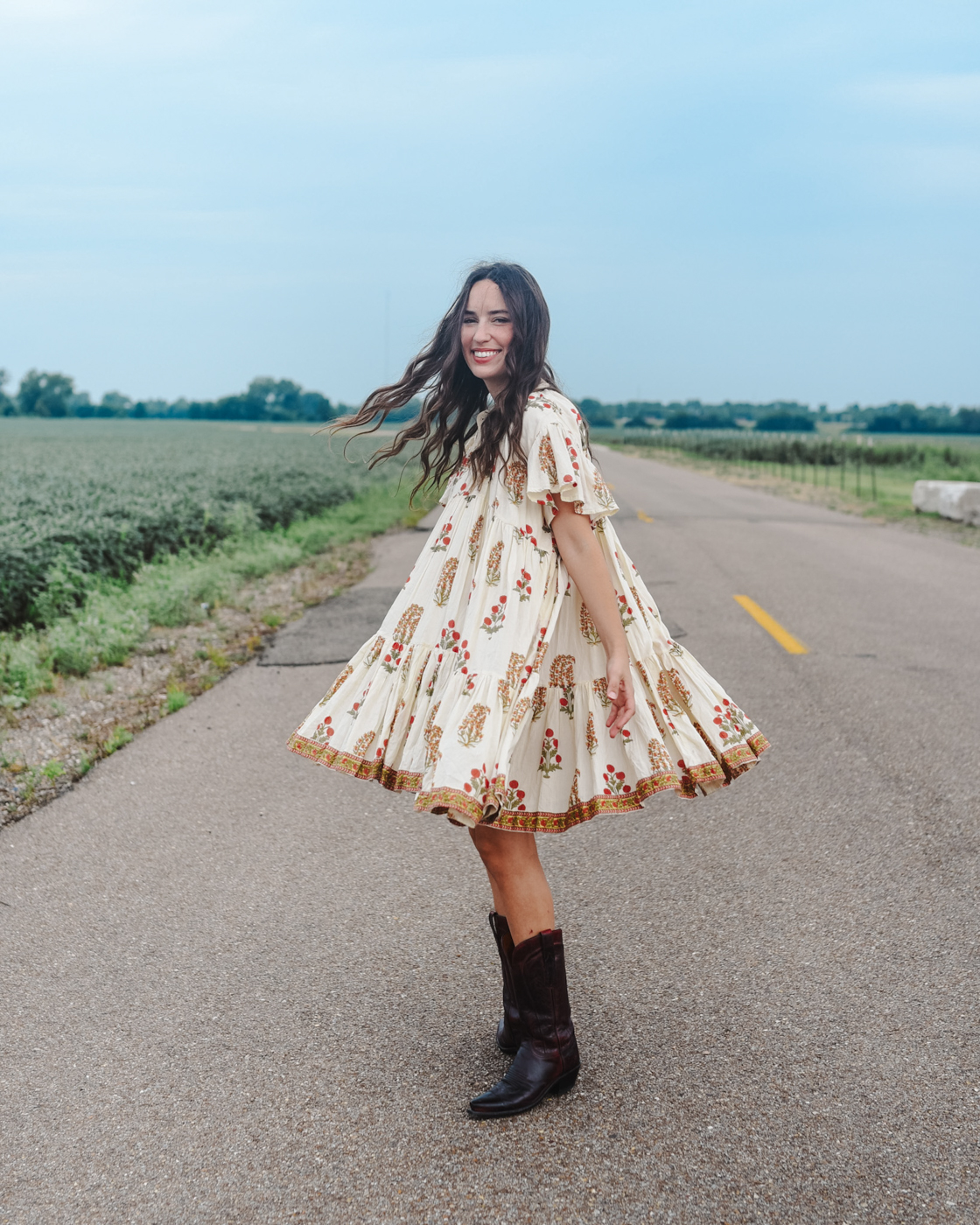 lekha block print lopa III dress, black cherry lucchese boots, alice kerley tennessee blogger | Babydoll Dress by popular Memphis fashion blog, Lone Star Looking Glass: image of a woman standing in a road and wearing a Lekah block print lopa III dress and black cherry lucchese boots.