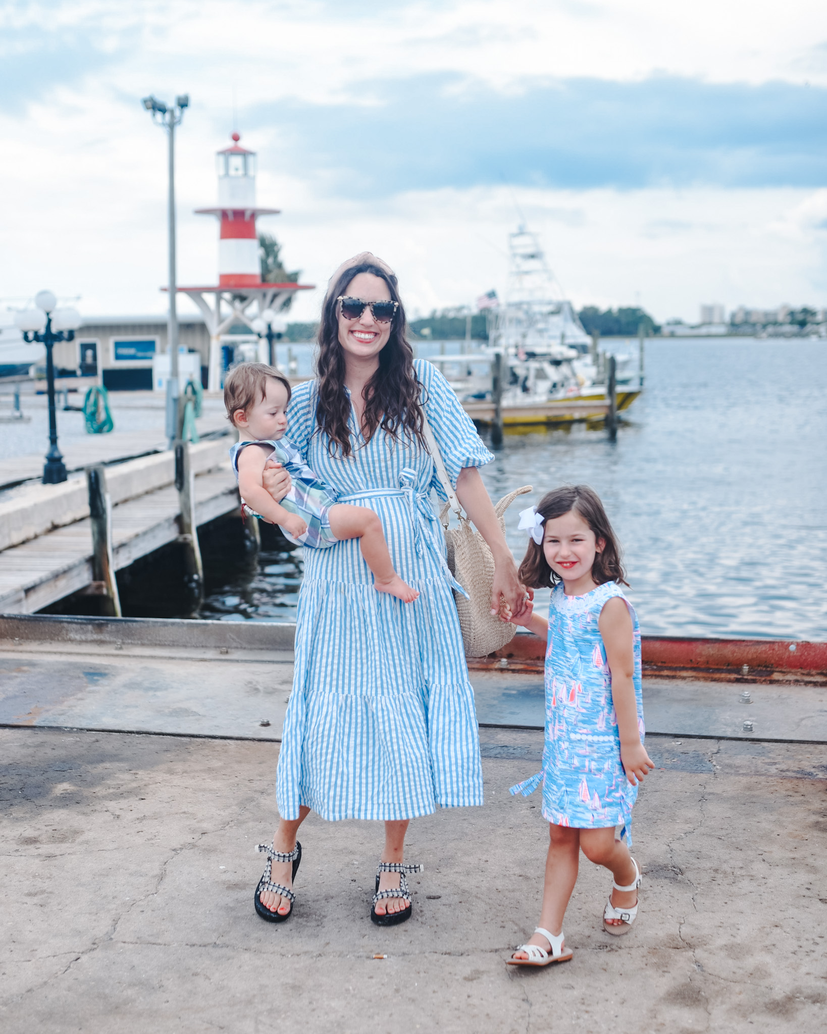 Panama City Beach Attractions by popular Memphis travel blog, Lone Star Looking Glass: image of a mom and her young son and daughter standing together on a dock. 